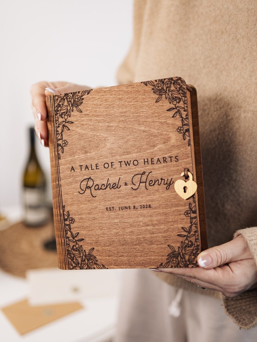 A person holding a book with a heart on it